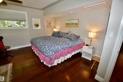 Bedroom featuring rich wood-finish flooring, recessed lighting, and a ceiling fan - 6 St George'S Crescent, Edmonton, AB 