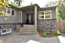 Exterior facade featuring a modern grey stucco finish and a stone veneer foundation - 6 St George'S Crescent, Edmonton, AB 