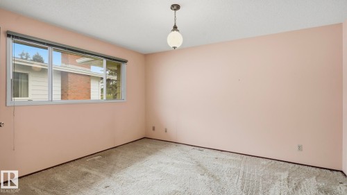 Interior room featuring neutral-toned carpeting and pastel pink walls - 7408 40 Avenue, Edmonton, AB 