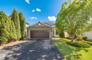 Exterior brick façade with an integrated two-car garage - 591 Byrne Crescent, Edmonton, AB 