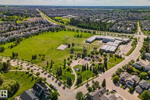 Expansive green spaces featuring a playground, sports fields, and Roberta MacAdams School (K-6) – about a 5 minute walk from the subject property. - 591 Byrne Crescent Sw, Edmonton, AB - Outdoor With View