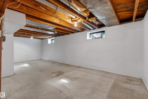 Open area featuring exposed wood ceiling joists and visible ductwork - 11417 65 Street, Edmonton, AB 