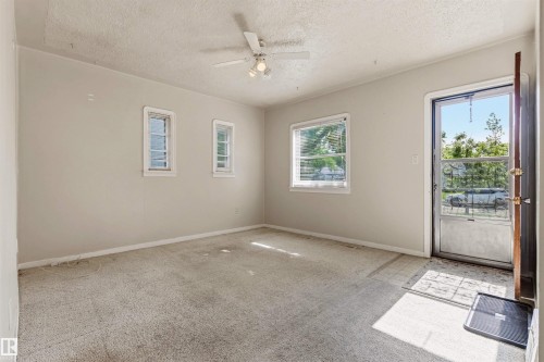 Entry area with light-colored walls and carpeted flooring - 11417 65 Street, Edmonton, AB 