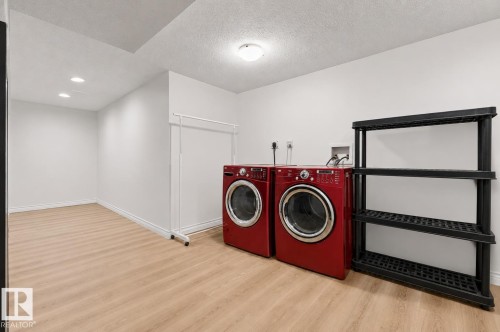 Dedicated laundry area featuring wood-finish flooring and recessed lighting - 11234 40 Avenue, Edmonton, AB 