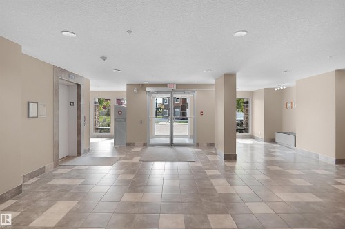Spacious lobby featuring neutral wall tones and large format tile flooring - 202 142 Ebbers Boulevard, Edmonton, AB 