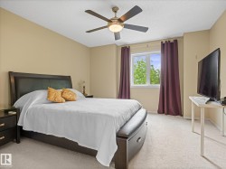 Spacious room featuring neutral wall tones, textured ceiling, and light-colored carpeting - 