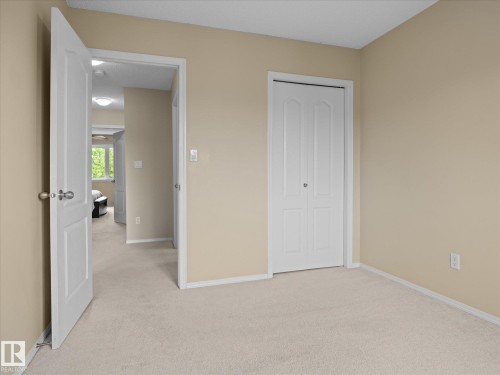 Neutral-toned wall paint throughout, complemented by light-toned carpet flooring - #88 5001 62 St, Beaumont, AB - Indoor