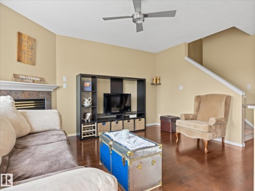 Living area featuring rich wood-finish flooring and a vaulted ceiling - #88 5001 62 St, Beaumont, AB - Indoor Photo Showing Living Room