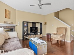 Living area featuring rich wood-finish flooring and a vaulted ceiling - 