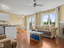 Open-concept living area with wood-finish flooring - 