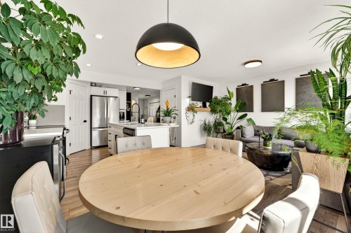 Open-concept living space featuring wood-finish flooring and recessed lighting - 20507 128 Avenue, Edmonton, AB 