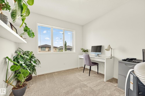Spacious room with light-toned carpeting and a large window - 20507 128 Avenue, Edmonton, AB 