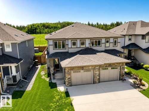 Contemporary two-story residence featuring a shingle roof and a combination of siding and stone veneer on the exterior - 20507 128 Avenue, Edmonton, AB 