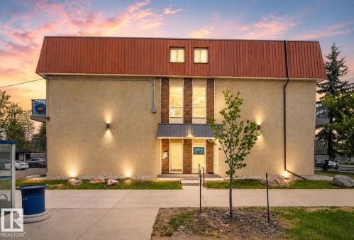 Contemporary exterior with stucco finish and a distinctive red metal roofline - 204 12404 114 Avenue, Edmonton, AB - Outdoor