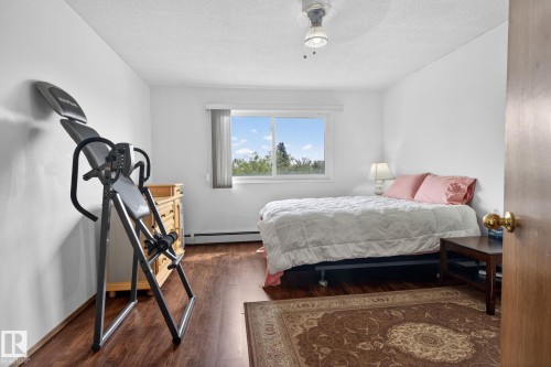 Bright room with wood-finish flooring, a double window, and a ceiling-mounted light fixture - 204 12404 114 Avenue, Edmonton, AB - Indoor Photo Showing Bedroom