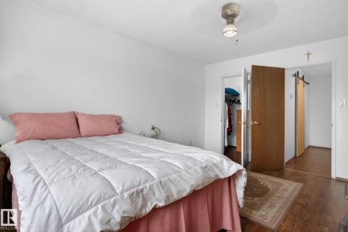 Room featuring wood-finish flooring, white walls, and a ceiling-mounted light fixture - 204 12404 114 Avenue, Edmonton, AB - Indoor Photo Showing Bedroom