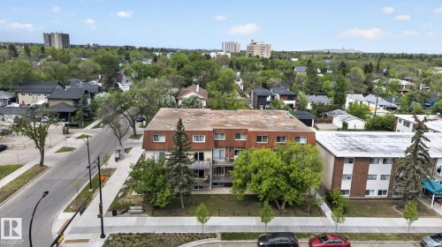 Multi-story apartment building with a brick and stucco facade, featuring private balconies on multiple levels - 204 12404 114 Avenue, Edmonton, AB - Outdoor With Balcony