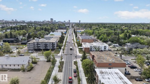 Aerial perspective showcasing a tree-lined thoroughfare with a cityscape on the horizon - 204 12404 114 Avenue, Edmonton, AB - Outdoor With View