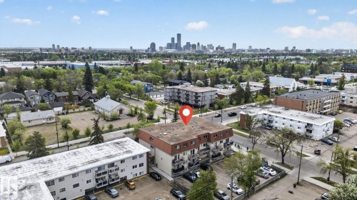 Four-story residential building with a brown roof and individual balconies - 204 12404 114 Avenue, Edmonton, AB - Outdoor With View