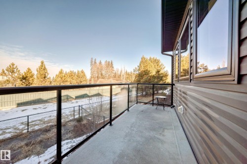 Exterior balcony with glass railings and dark-framed windows - 46 1304 Rutherford Road, Edmonton, AB - Outdoor With Exterior