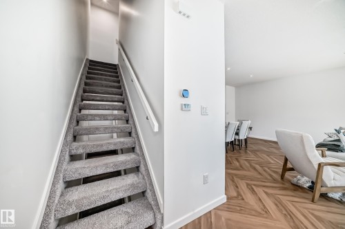 Carpeted staircase with white handrail and recessed lighting - 46 1304 Rutherford Road, Edmonton, AB - Indoor Photo Showing Other Room