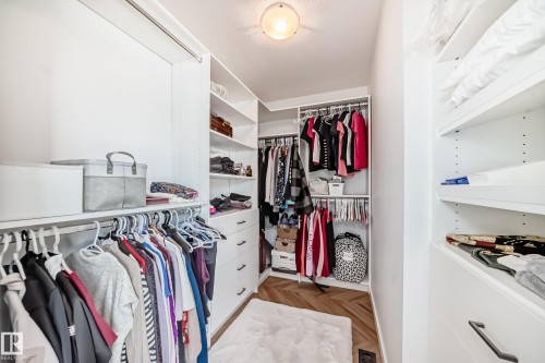 Custom closet system featuring white shelving and integrated drawers - 46 1304 Rutherford Road, Edmonton, AB - Indoor With Storage