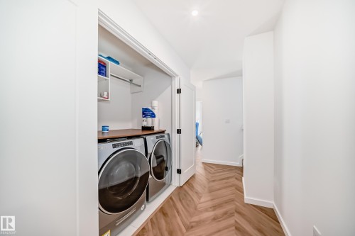 Dedicated laundry closet with built-in shelving, a hanging rod, and a wood-finish countertop - 46 1304 Rutherford Road, Edmonton, AB - Indoor Photo Showing Laundry Room