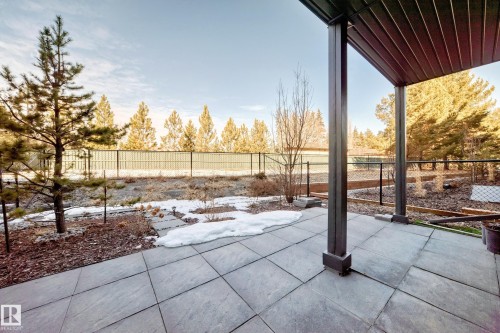 Covered patio featuring large format pavers and dark structural columns - 46 1304 Rutherford Road, Edmonton, AB - Outdoor