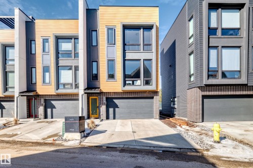 Modern multi-story facade featuring wood-look siding and dark gray panels - 46 1304 Rutherford Road, Edmonton, AB - Outdoor With Facade