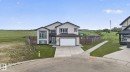 Contemporary exterior with light-toned siding and dark trim accents - 4204 55Av, Lamont, AB 
