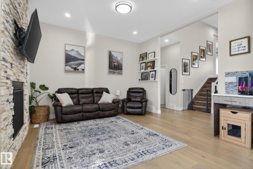 Spacious living area featuring light wood-finish flooring and recessed lighting - 4204 55Av, Lamont, AB 