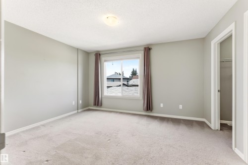 Carpeted room with light grey walls and white trim - 8204 180 Avenue, Edmonton, AB 