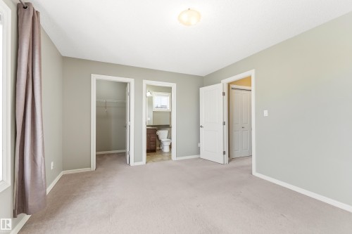 Carpeted room with neutral wall tones and a ceiling-mounted light fixture - 8204 180 Avenue, Edmonton, AB 