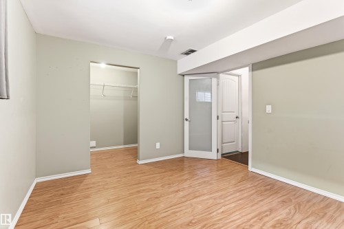 Room featuring wood-finish flooring and light-toned walls - 8204 180 Avenue, Edmonton, AB 