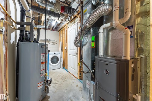 Utility area featuring a water heater, furnace, and a clothes washer - 8204 180 Avenue, Edmonton, AB 