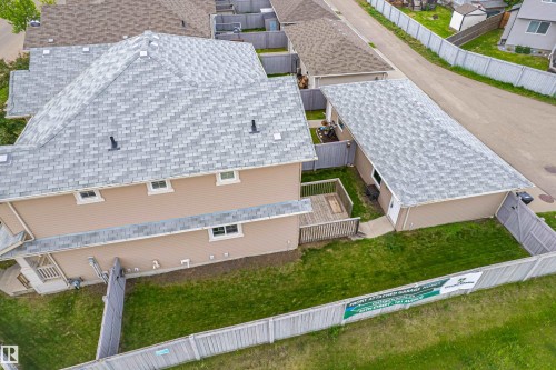 Exterior featuring a light tan siding and a grey shingle roof - 8204 180 Avenue, Edmonton, AB 
