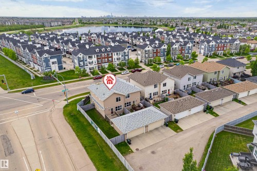 Two-story residence featuring a neutral-toned exterior, an asphalt shingle roof, and a fenced backyard - 8204 180 Avenue, Edmonton, AB 