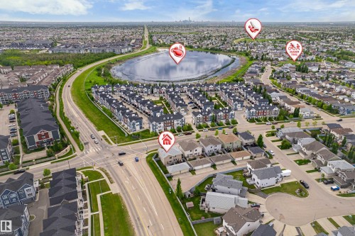 Aerial overview showcasing a residential district with a central lake and surrounding green spaces - 8204 180 Avenue, Edmonton, AB 