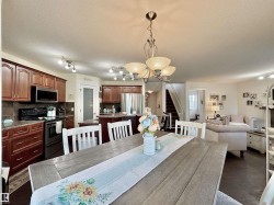 Open-concept living space with dark wood-finish flooring - 