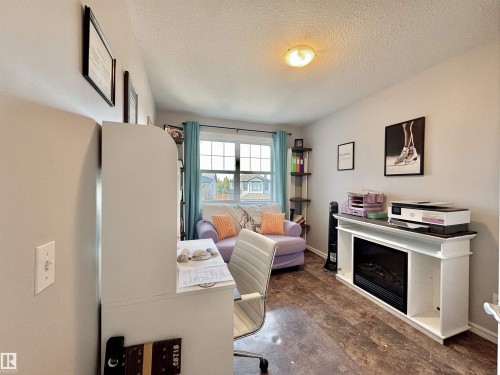 Interior room featuring wood-finish flooring, a double window with blinds, and light-toned walls - 105 Greystone Crescent, Spruce Grove, AB 