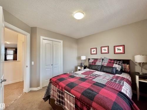 Neutral-toned bedroom featuring carpeted flooring and a flush-mount ceiling light - 105 Greystone Crescent, Spruce Grove, AB 