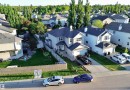 Two-story residence with light-colored siding and dark shingle roofing - 105 Greystone Crescent, Spruce Grove, AB 