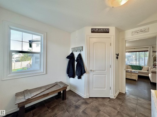 Entryway featuring durable ceramic tile flooring and a double-pane window - 105 Greystone Crescent, Spruce Grove, AB 