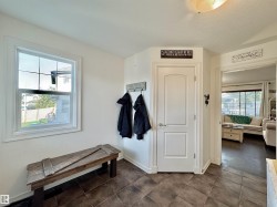 Entryway featuring durable ceramic tile flooring and a double-pane window - 