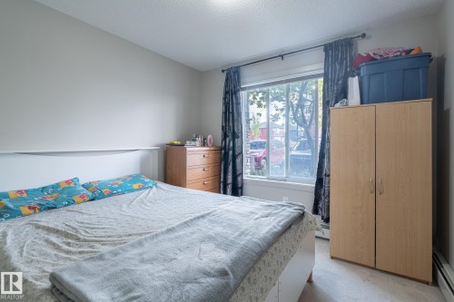 Bedroom featuring light neutral wall paint and a single window - 107 142 Ebbers Boulevard, Edmonton, AB 