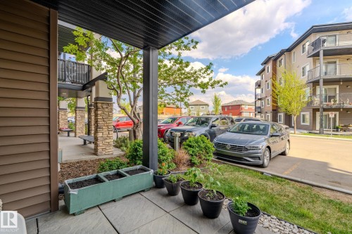 Covered patio space featuring a concrete slab and a built-in planter - 107 142 Ebbers Boulevard, Edmonton, AB 