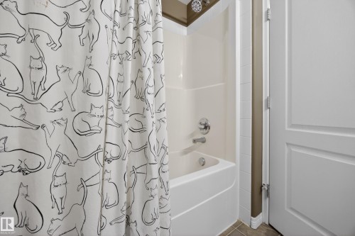 Bathtub and shower combination featuring a white surround and chrome fixtures - 111 3425 19, Edmonton, AB 