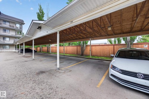 Covered parking structure with multiple spaces, featuring a light-colored soffit and a wood-finish ceiling - 111 3425 19, Edmonton, AB 