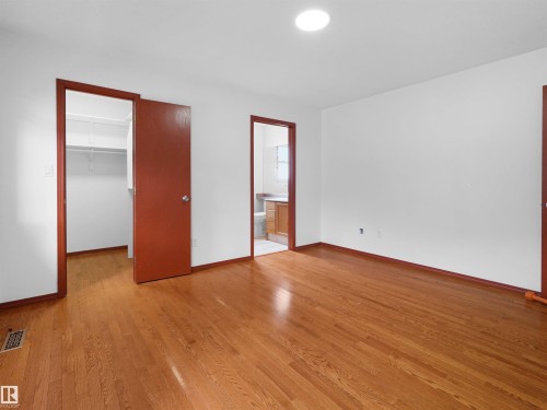 Spacious room with wood-finish flooring and white walls - 2832 36B Avenue, Edmonton, AB - Indoor Photo Showing Other Room