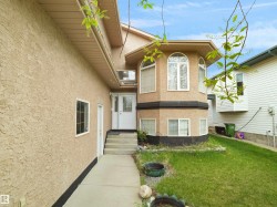 Stucco exterior featuring multiple window styles - 